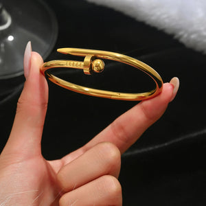 Elegant gold bracelet in nail design: bold, modern and timeless